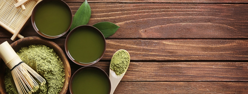 matcha green tea and matcha powder with bamboo and wooden spoons