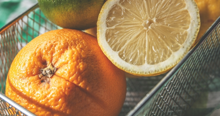 Oranges, lemons and limes with green gingham kitchen towel
